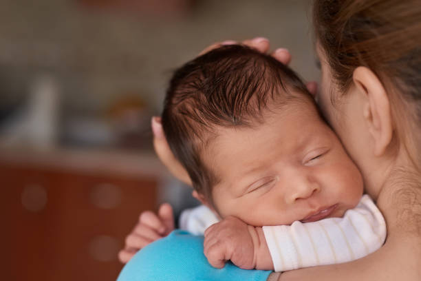 istock sleeping in my mother's arms 943424156