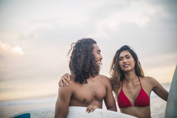 istock Young couple surfers at the beach 943435000