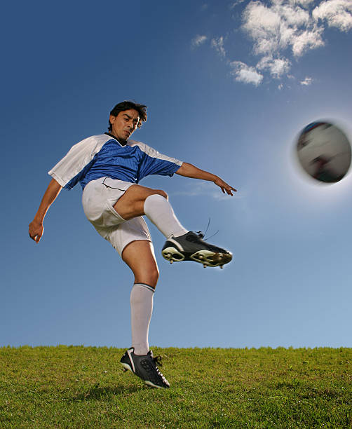 istock Soccer player in blue jersey hitting the ball 94344077