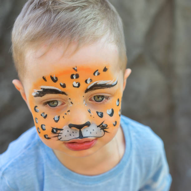 istock child painted in the face as a tiger 943440986