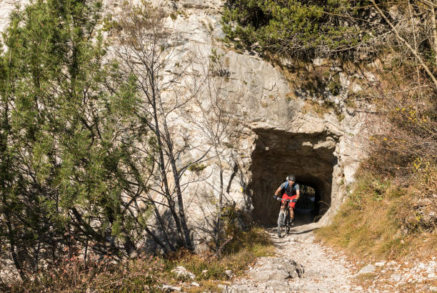 istock Male mountainbiker leaving tunnel, Italy. 943441046
