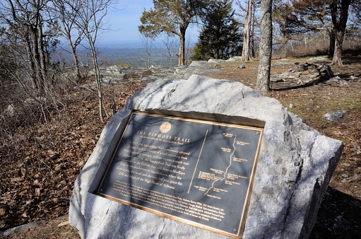 Delta, Alabama, USA - February 4, 2017: Monument plaque on a mountain near Cheaha State Park in Delta, Alabama that reads The Pinhoti Trail Alabama's Link to the Appalachian Trail.