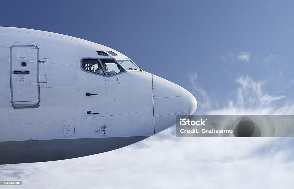 Airplane flying in front of blue sky  Airplane Stock Photo