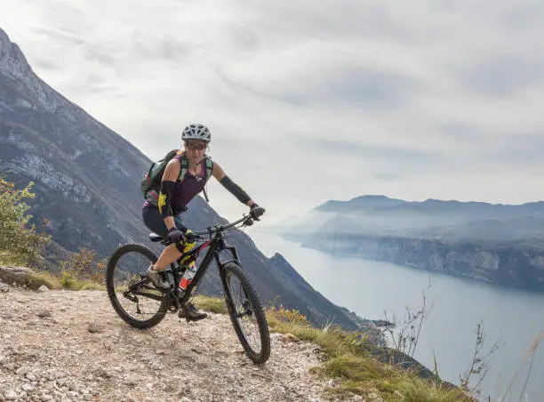 A well equipped and experienced female mountainbiker is taking a hairpin curve high above Lake Garda nearby the village of Riva in the northern part of Italy on a misty day in autumn.
Canon EOS 5D Mark IV, 1/400, f/8, 35 mm.