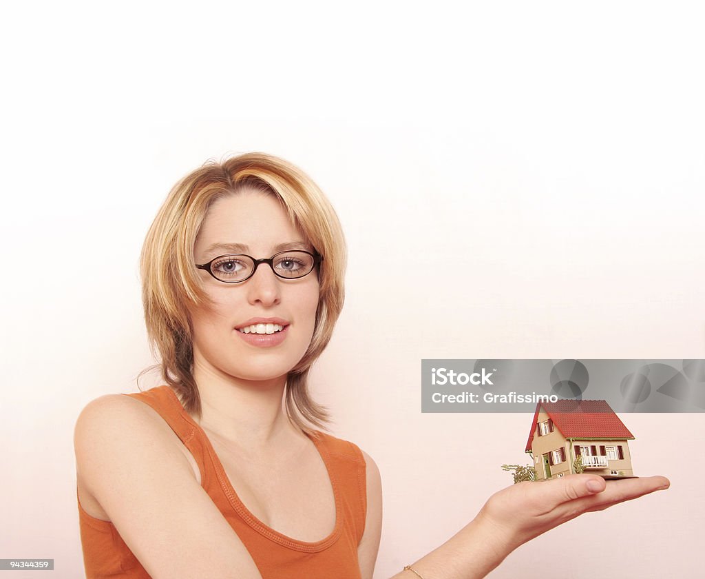 Blonde woman offering a house  Adult Stock Photo