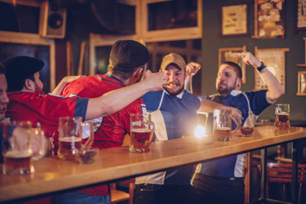 istock Group of fans fighting in bar 943443734