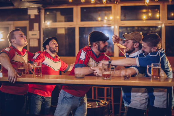 istock Men fighting in sports bar 943443838