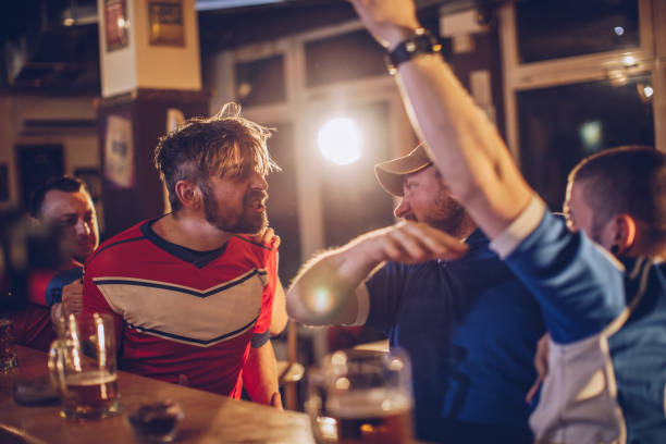 Fans fighting in sports bar Group of men fighting in sports bar gripping bars stock pictures, royalty-free photos & images