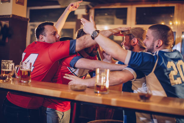 Men fighting in sports pub