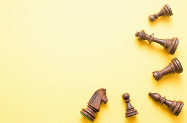 istock Chess game figures on yellow background , top view, flat lay copy space 943449444