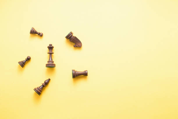 istock Chess game figures on yellow background , top view, flat lay copy space 943449618