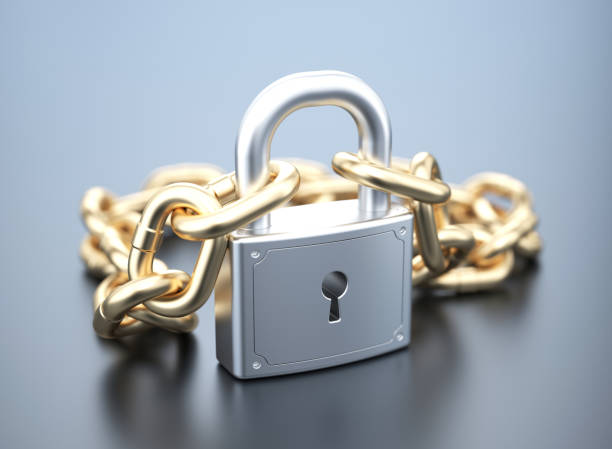 istock Silver padlock with golden chain 943455450