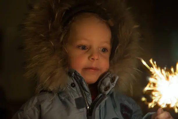 Photo of Happy boy with fireworks in his hands.