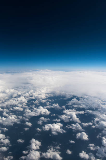 istock Beautiful view from window of airplane in blue sky 943460764