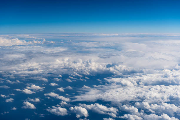 istock Beautiful view from window of airplane in blue sky 943465384