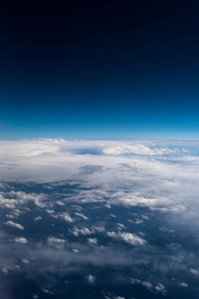 istock Beautiful view from window of airplane in blue sky 943465546