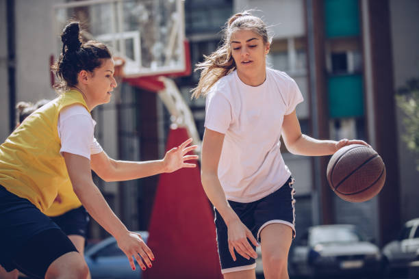 istock Women friends playing basketball 943465916