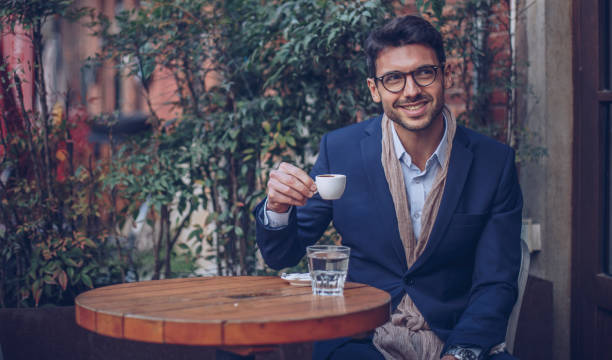 istock Handsome man sitting in coffee shop 943472880