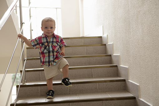 Child going upstairs in hotel in morning