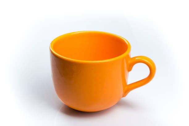 istock Orange cup of coffee on a White background. bowl 943488594