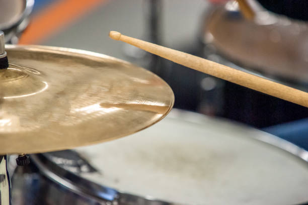 istock Drummer playing on drum set top view. Live music concert, band during performance. View and look through allong cymballs on snare drum and drum sticks 943494536