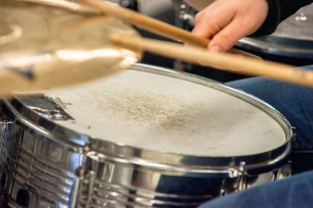 istock Drummer playing on drum set top view. Live music concert, band during performance. View and look through allong cymballs on snare drum and drum sticks 943494544