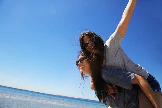 istock Young friends enjoying their summer vacation on beach 943499218