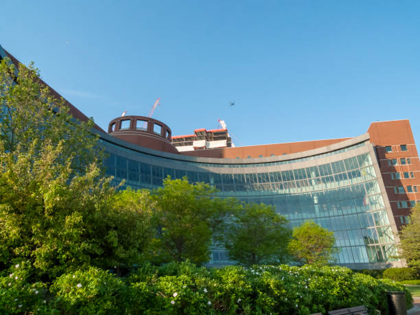 Moakley courthouse One Seaport Square jet South Boston, Massachusetts, USA - May 26, 2016: Early morning view of Moakley courthouse with aircraft and construction at One Seaport Square in background harborwalk stock pictures, royalty-free photos & images