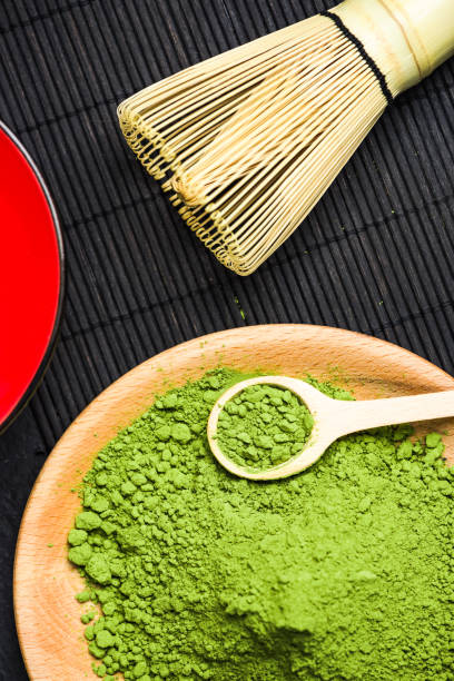 istock Matcha green powder and bamboo tea whisk 943502072