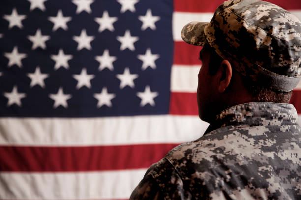 istock USA armed forces military man with American flag. 943506334