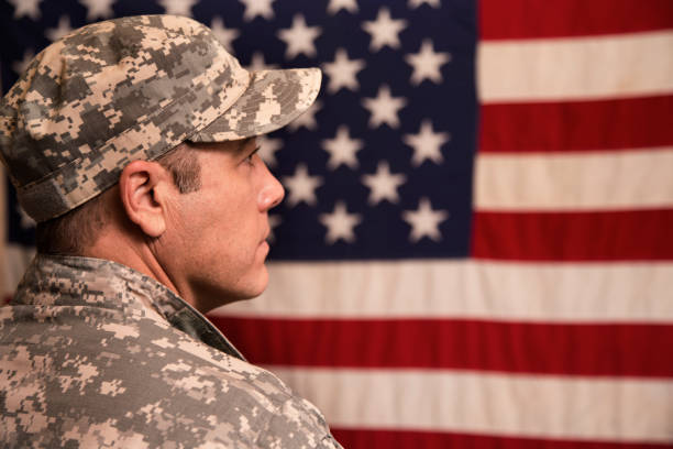 istock USA armed forces military man with American flag. 943506410