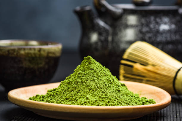 istock Wooden pot with green matcha tea powder 943506412