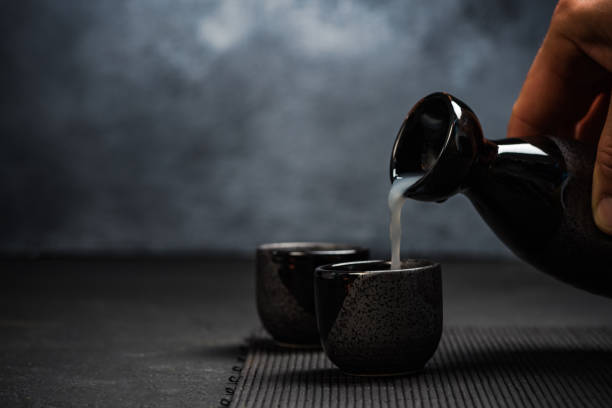istock Man pouring sake into sipping bowl 943510124