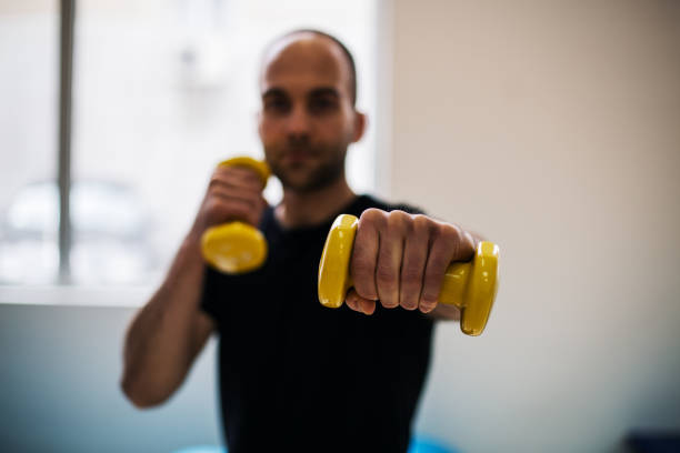 istock Man working out in the fitness center 943524708