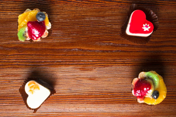 small delicious fruit cakes on the wood background