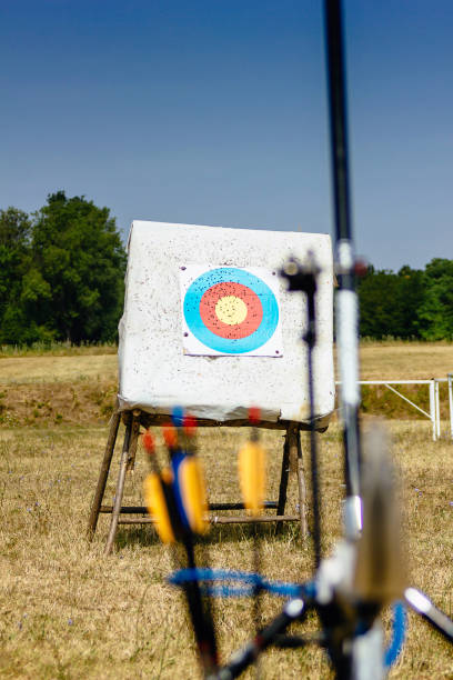 istock archery equipment with target in the background 943542738