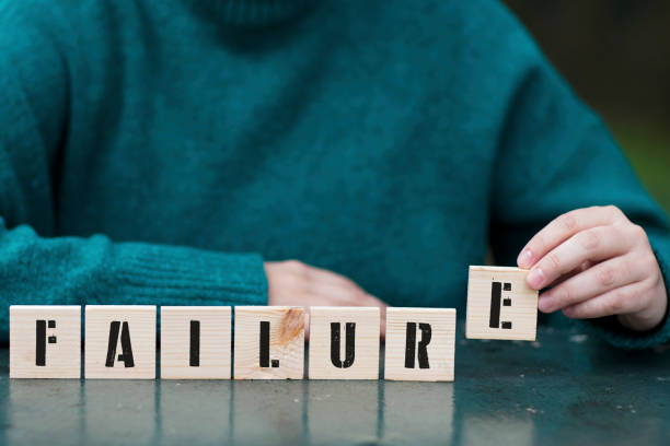 Failure, Female hand playing with seven wooden blocks