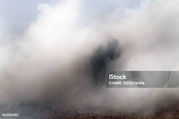 Man In A Cloud Of Smoke Stock Photo - Download Image Now - Tear Gas, Smoke - Physical Structure, Violence