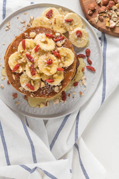 istock Pancakes with banana, walnuts, goji and honey 943551860