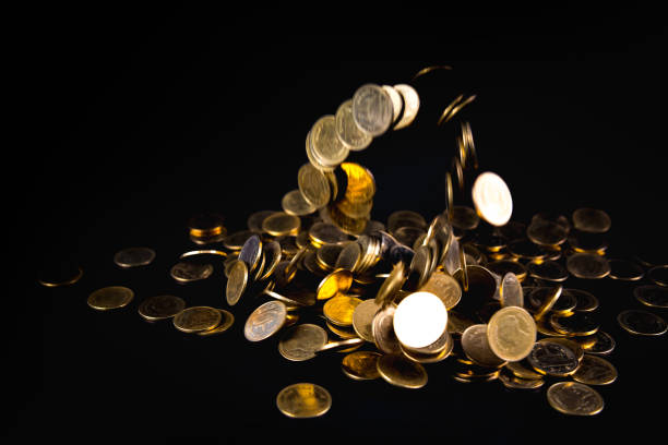 istock Falling gold coins money in dark background, business concept. 943557770