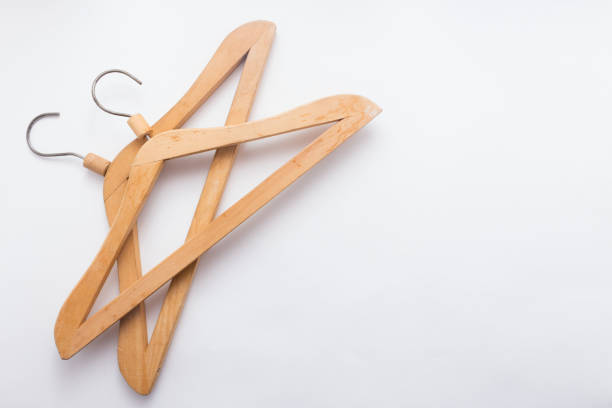 istock Wooden hanger for clothes on white background top view flat lay copy space 943561194