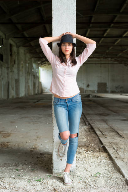 istock Young trendy woman wearing hat posing 943566794