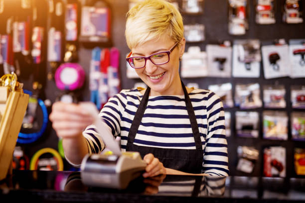 istock Beautiful cheerful woman while pulling out a check from the cashier. 943566938