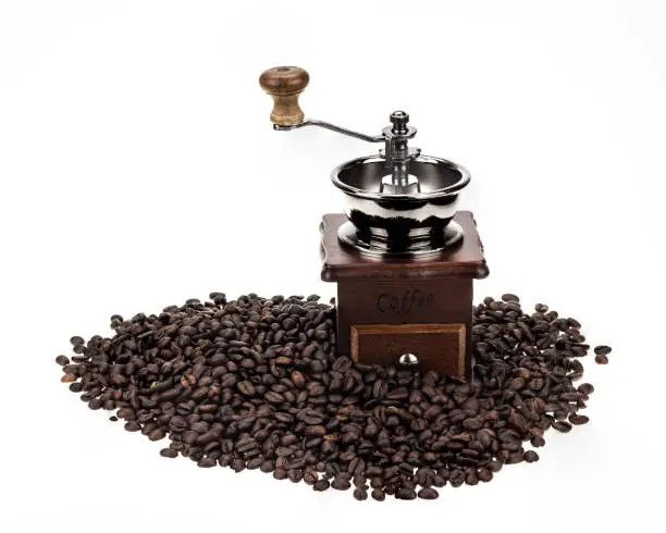 Coffee seed brown color on white background with coffee grinder brown color.