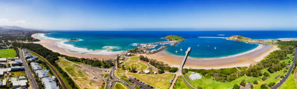 D Coffs Harbour Land 2 Sea Pan Coffs harbour regional town on NSW North coast in elevated aerial view - wide panorama of town's beach, marina, harbour and muttonbird island. coffs harbour stock pictures, royalty-free photos & images