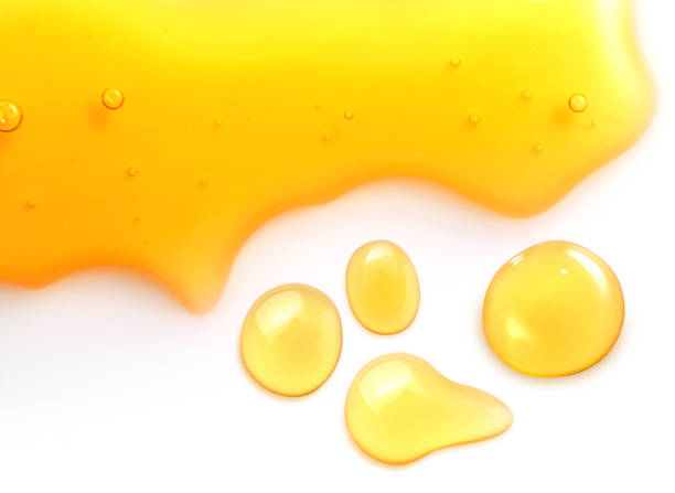 istock Macro close up of  honey drops isolated on white background 943575772