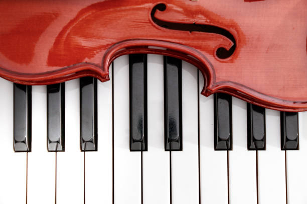 istock classical violin on white and black piano keys close-up background 943576860