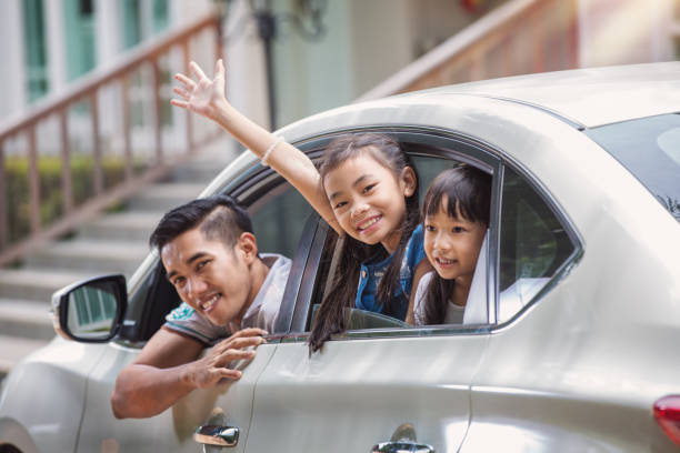Father and daughter on car and smile from car windows Father and daughter on car and smile from car windows before start family travel trip in holiday, this immage can use for family , travel, car, weekend, and summer concept happy car asian stock pictures, royalty-free photos & images