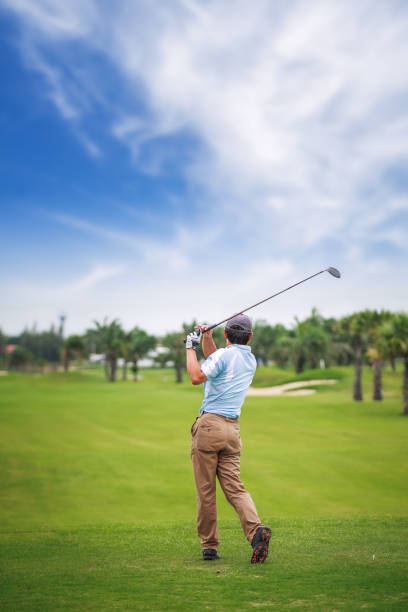 istock Asian Golf player on tee off green after swing 943584808