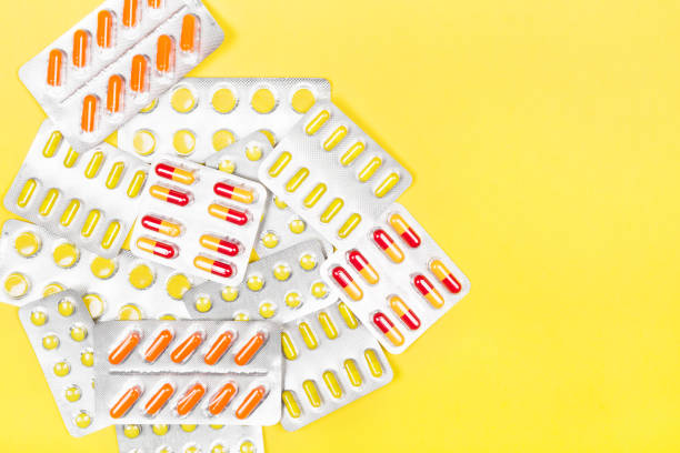 istock Various medicine pills on yellow background. Top view, copy space 943601776